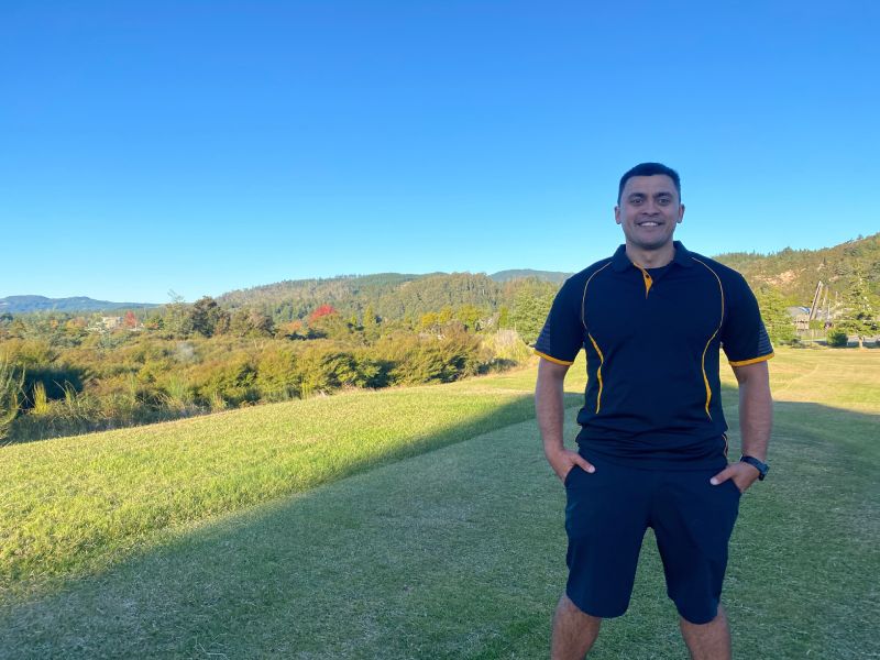 Stanley Ulrich standing on top of a grassy hill in Rotorua.