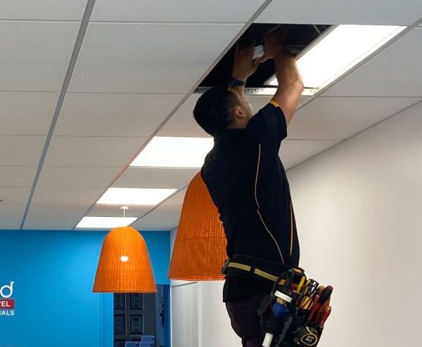 Stanley Ulrich fitting moving some wires in the ceiling of a commercial business.